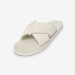 Beige sandal with a criss-cross strap on a white background