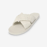 Beige sandal with a criss-cross strap on a white background
